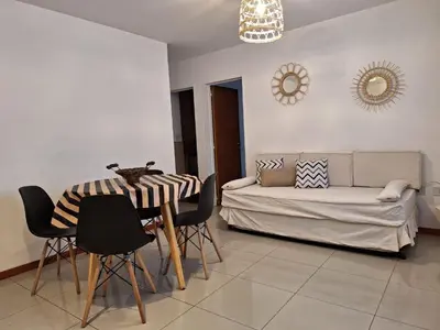 a living room with a table and a couch at Departamento Cofico in Cordoba