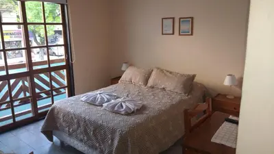 a bedroom with a bed with two towels on it at Hotel Lihuel in Villa Carlos Paz