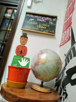 a globe sitting on top of a wooden table at Rivera Hostel Córdoba in Cordoba