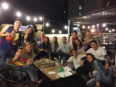 a group of people posing for a picture in a restaurant at Rivera Hostel Córdoba in Cordoba