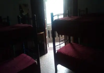 a group of bunk beds in a room with a window at Rivera Hostel Córdoba in Cordoba