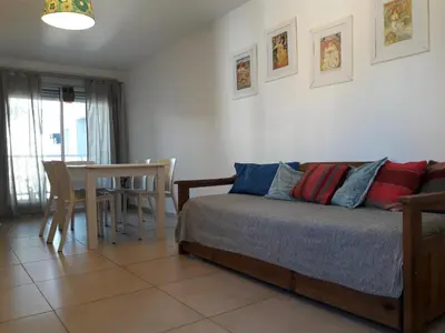 a bedroom with a bed and a table and chairs at Espacio C San Juan con cochera in Cordoba