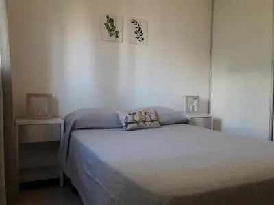 a bedroom with a bed and two night stands at Espacio C San Juan con cochera in Cordoba
