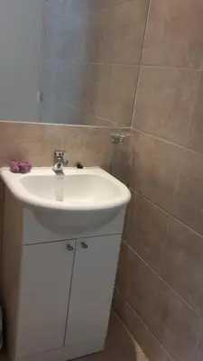 a bathroom with a white sink and a mirror at Espacio C San Juan con cochera in Cordoba