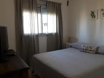 a small bedroom with a bed and a window at Espacio C San Juan con cochera in Cordoba