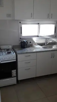 a small kitchen with a stove and a sink at Espacio C San Juan con cochera in Cordoba