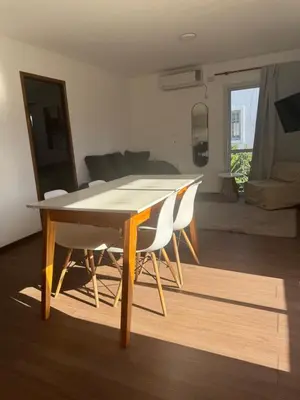 a dining table and chairs in a living room at Hermoso departamento in Villa Carlos Paz