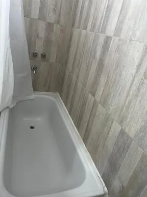 a shower with a white tub in a bathroom at Hermoso departamento in Villa Carlos Paz