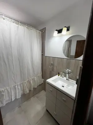 a bathroom with a sink and a shower curtain at Hermoso departamento in Villa Carlos Paz