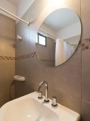 a bathroom with a sink and a mirror at Concord Rent Apart in Cordoba