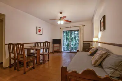 a living room with a bed and a table and chairs at Concord Rent Apart in Cordoba