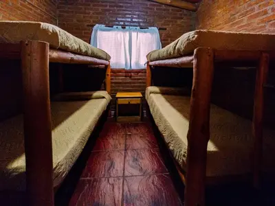 two bunk beds in a room with a window at Quebrada del Viento - Cabañas in Los Hornillos