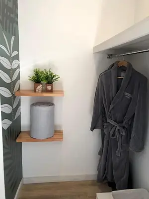 a robe hanging on a shelf in a room at Magnolia Suites in Nono