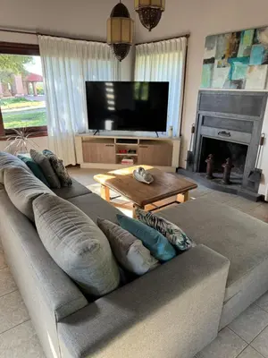 a living room with a couch and a television at Lirios del Campo - Chumamaya Merlo SL in Merlo