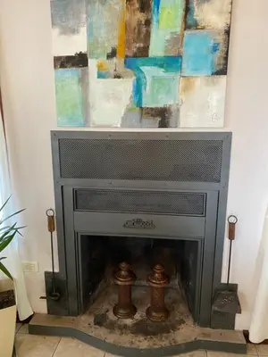 a fireplace in a living room with a painting at Lirios del Campo - Chumamaya Merlo SL in Merlo