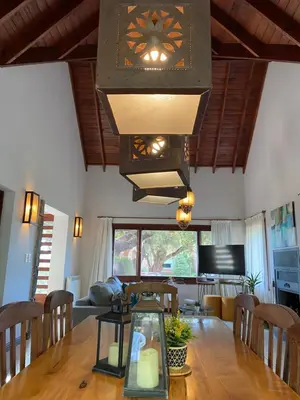 a dining room with a large clock hanging over a table at Lirios del Campo - Chumamaya Merlo SL in Merlo