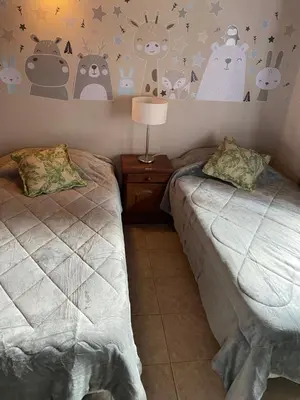a bedroom with two beds and a lamp on a table at Lirios del Campo - Chumamaya Merlo SL in Merlo