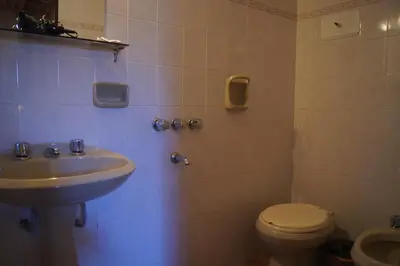 a bathroom with a toilet and a sink at Lorelei in Mina Clavero