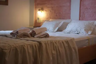 a bed with blankets and pillows on top of it at Lorelei in Mina Clavero