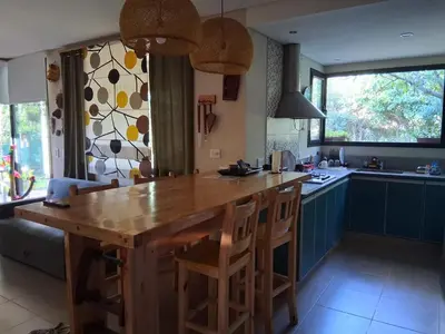 a kitchen with a large wooden table and chairs at La Llilda in La Bolsa