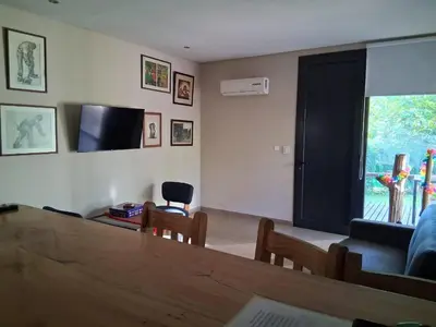 a living room with a couch and a television at La Llilda in La Bolsa