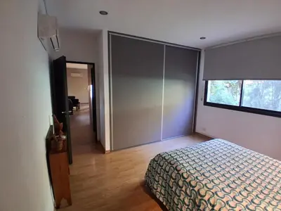 a bedroom with a bed and a sliding glass door at La Llilda in La Bolsa