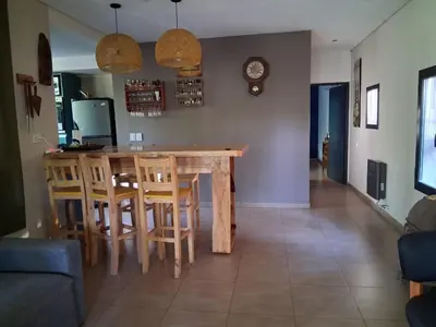 a kitchen and dining room with a table and chairs at La Llilda in La Bolsa