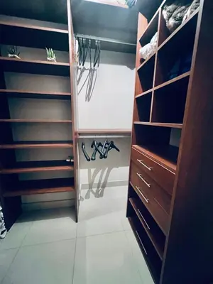 a walk in closet with wooden cabinets and shoes at Deluxe Nueva Córdoba - Premium Balcón & Asador in Cordoba