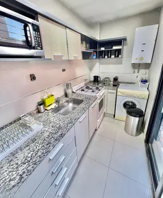 a kitchen with a sink and a stove at Deluxe Nueva Córdoba - Premium Balcón & Asador in Cordoba
