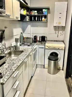 a small kitchen with a stove and a sink at Deluxe Nueva Córdoba - Premium Balcón & Asador in Cordoba