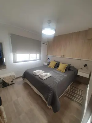 a bedroom with a large bed with yellow pillows at Aldea Mate Amargo in Potrero de Garay
