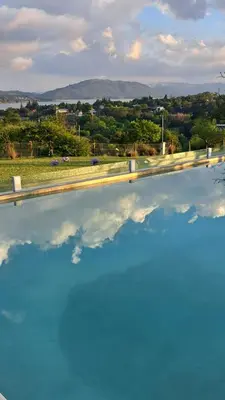 a pool of water with a reflection of the sky at Aldea Mate Amargo in Potrero de Garay