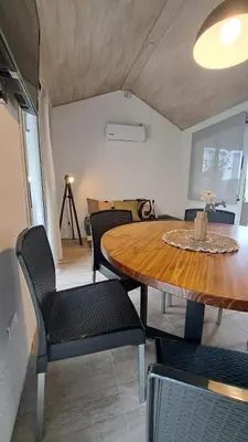 a dining room with a table and chairs and a room at Aldea Mate Amargo in Potrero de Garay