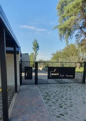 a gate with a sign that reads samurai hallagency at Aldea Mate Amargo in Potrero de Garay