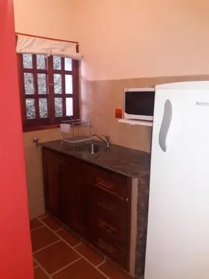 a kitchen with a sink and a refrigerator at Cabañas La Belen in Merlo
