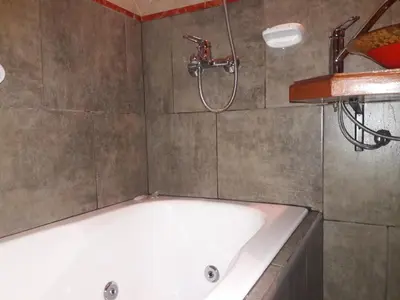 a bath tub in a bathroom with a shower at Cabañas La Belen in Merlo