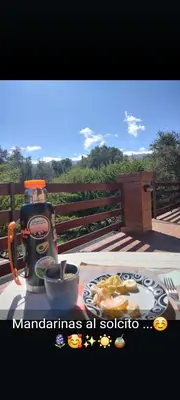 a table with a coffee maker and a plate of food at Cabañas La Belen in Merlo