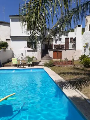 a swimming pool in front of a house at Loma del Alto in Alta Gracia