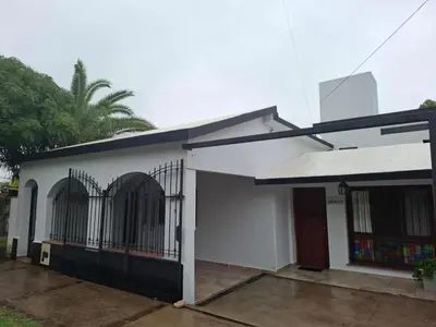a white house with a gate in front of it at Loma del Alto in Alta Gracia