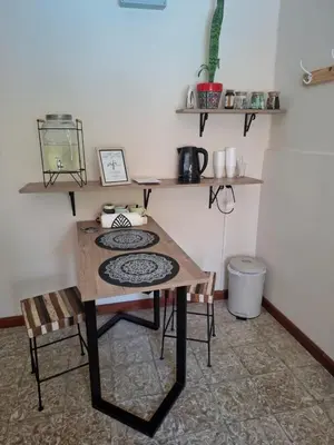 a kitchen with a table and two chairs and a table at Loma del Alto in Alta Gracia