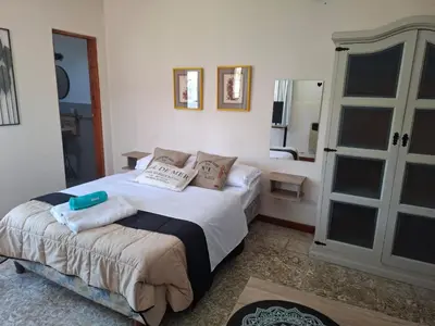 a bedroom with a large bed with pillows on it at Loma del Alto in Alta Gracia