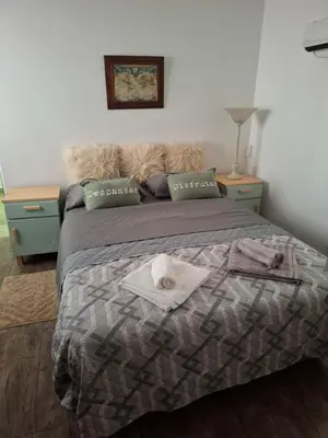 a bedroom with a bed with a towel on it at Loma del Alto in Alta Gracia