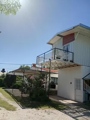 a building with a balcony on the side of it at Refugio Amaicha in Embalse
