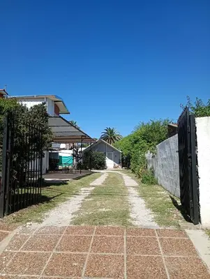 an empty driveway with a fence and a house at Refugio Amaicha in Embalse