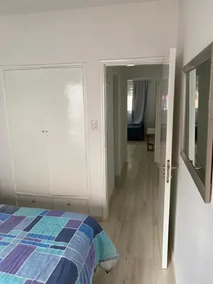 a bedroom with a bed and a door to a hallway at Departamento HOSPITAL PRIVADO - QUALITY - CORDOBA in Cordoba