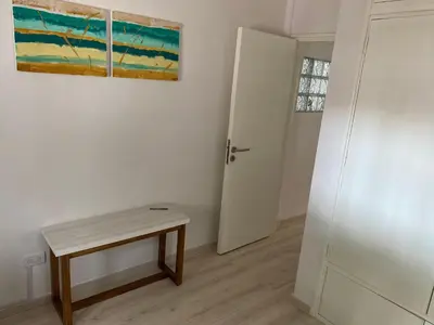 a room with a table and a painting on the wall at Departamento HOSPITAL PRIVADO - QUALITY - CORDOBA in Cordoba
