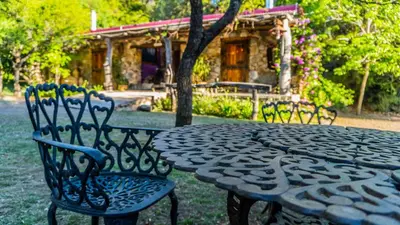 a stone table and chairs with a table and chairs at Araoz de Lamadrid Wine Lodge in San Javier