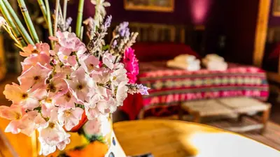 a vase filled with pink flowers on a table at Araoz de Lamadrid Wine Lodge in San Javier