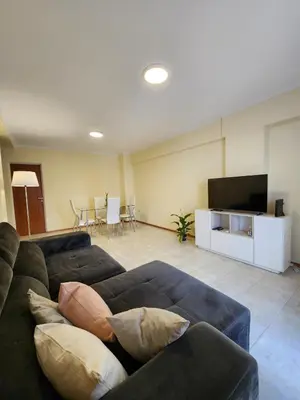 a living room with a couch and a flat screen tv at Obispo Oro 451 - Nueva Córdoba in Cordoba