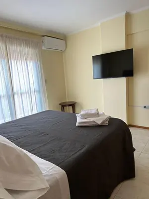 a bedroom with a bed with a tv on the wall at Obispo Oro 451 - Nueva Córdoba in Cordoba